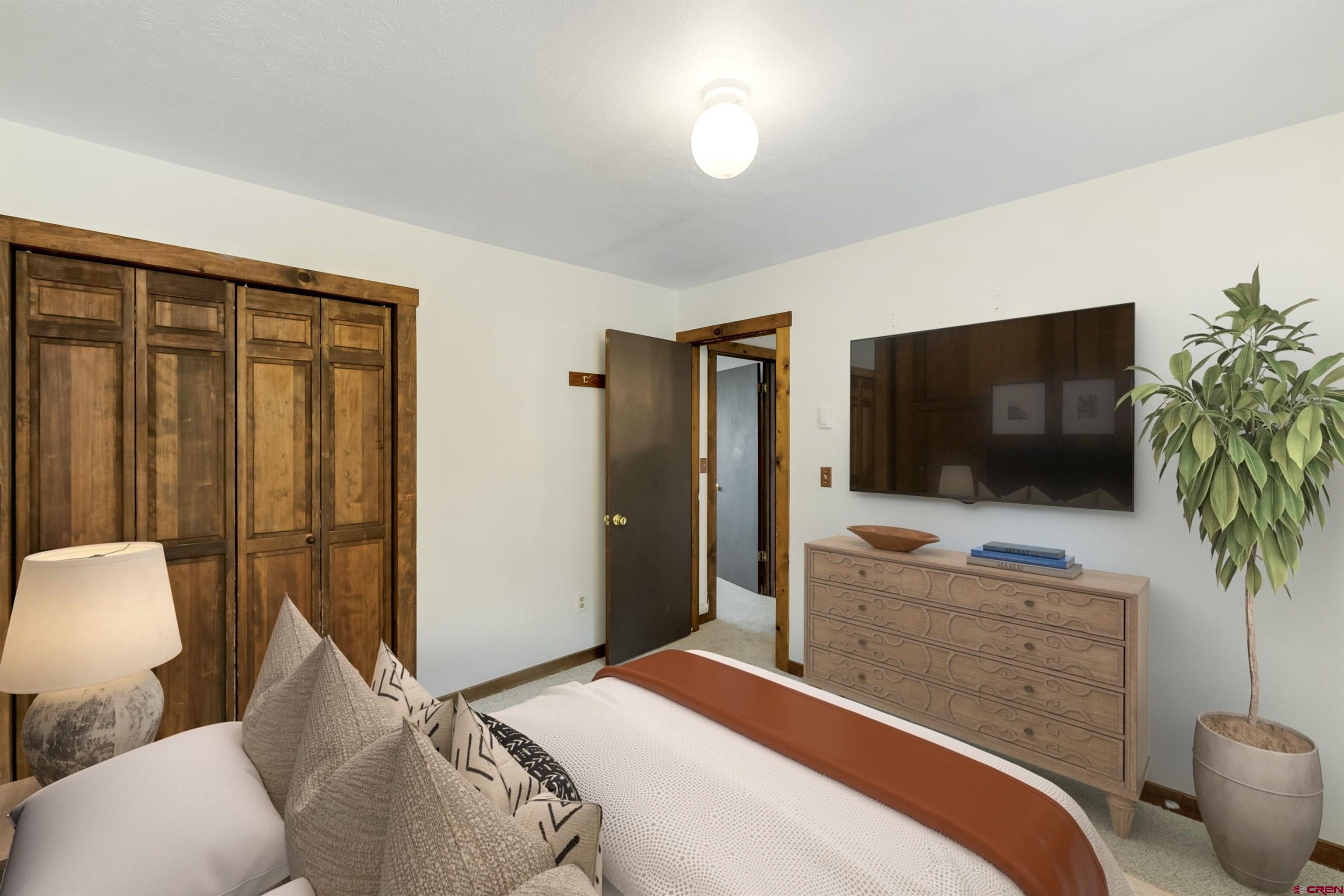 22 Castle Road, Unit 2 Crested Butte, CO 81225 - Photo 29 of 38 a bedroom with a bed and a flat screen tv
