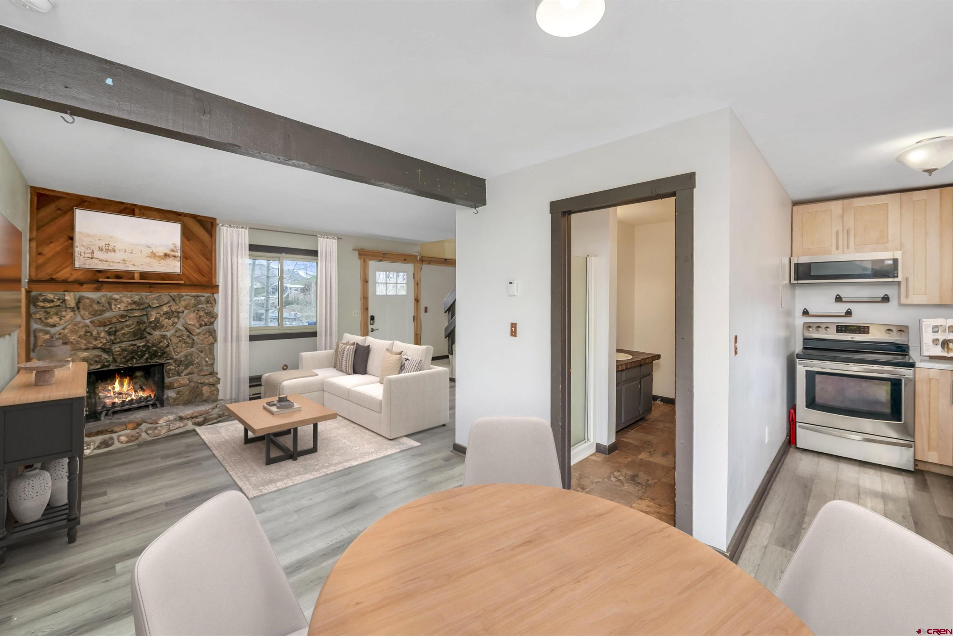 22 Castle Road, Unit 2 Crested Butte, CO 81225 - Photo 7 of 34 a living room with furniture and a fireplace