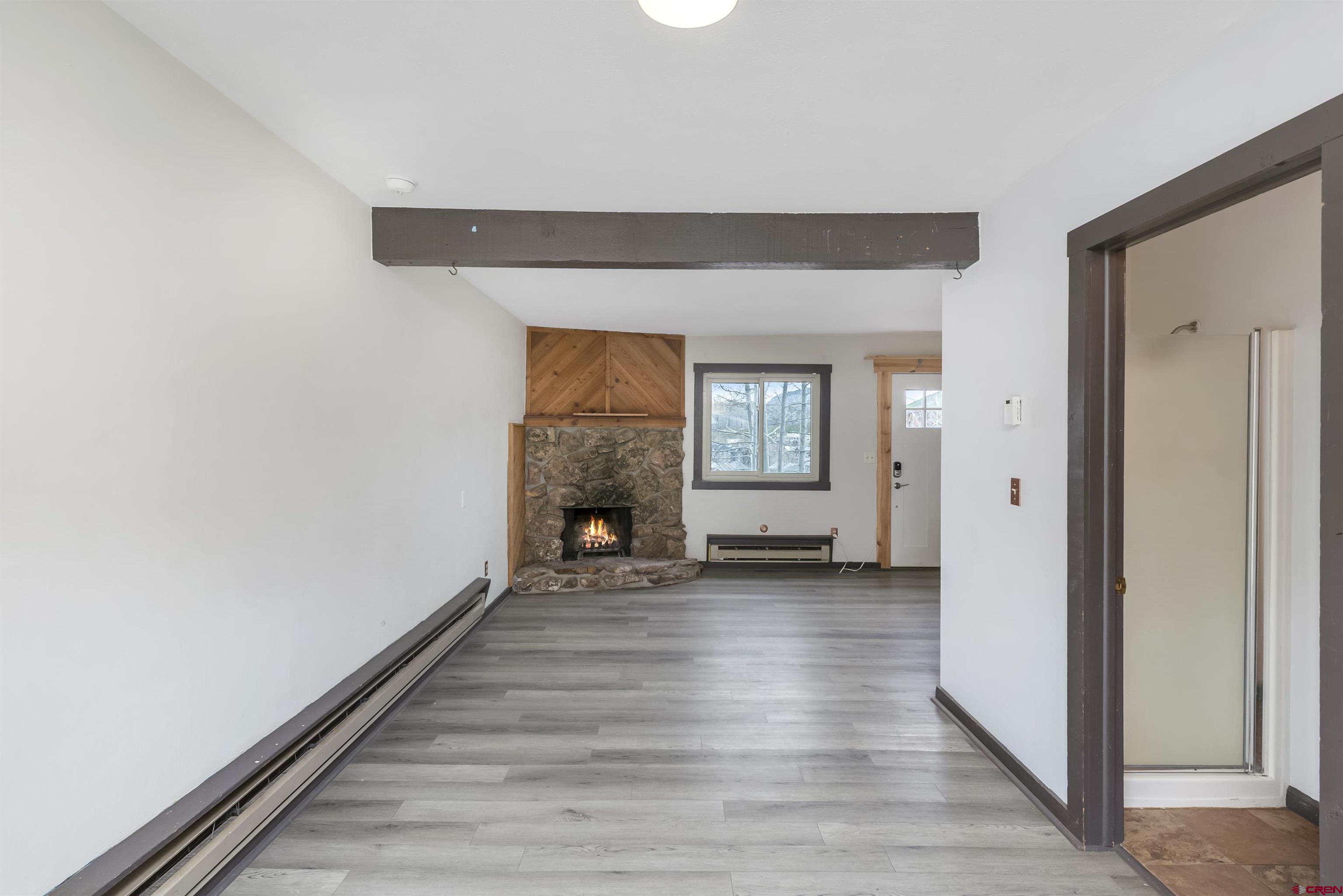 22 Castle Road, Unit 2 Crested Butte, CO 81225 - Photo 9 of 34 a view of a livingroom with wooden floor and a window