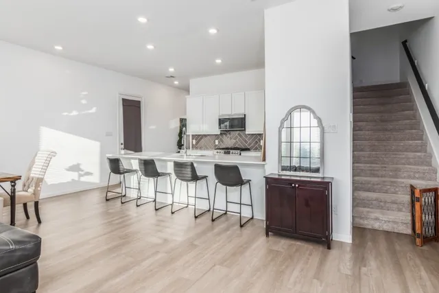 a kitchen with kitchen island a stove a sink and a refrigerator