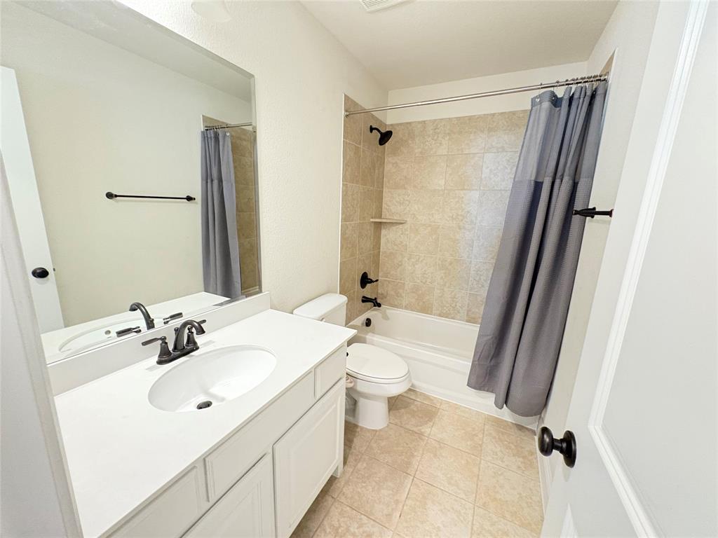 323 Butternut Way Irving, TX 75063 - Photo 26 of 32 a bathroom with a sink a toilet a mirror and shower