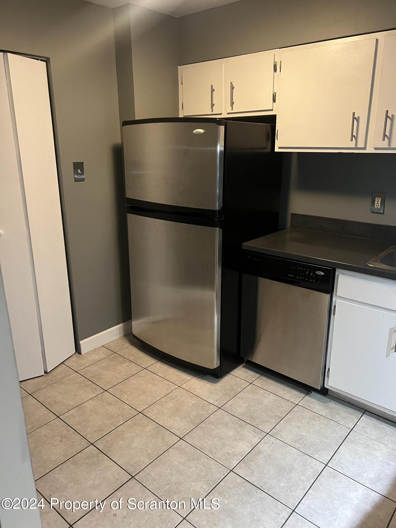 220 Linden Street, Unit 208 Scranton, PA 18503 - Photo 3 of 24 a kitchen with a refrigerator and a stove