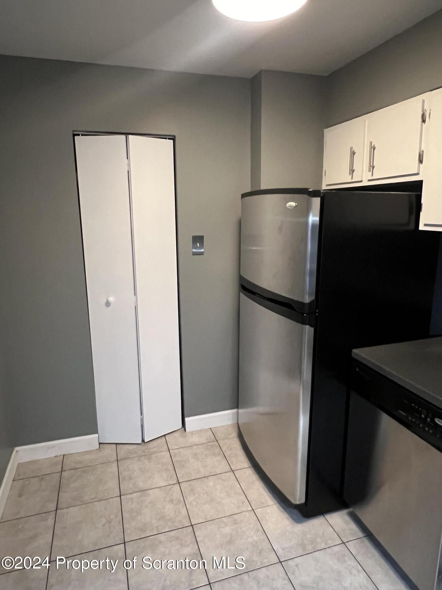 220 Linden Street, Unit 208 Scranton, PA 18503 - Photo 5 of 24 a white refrigerator freezer and a microwave in a kitchen