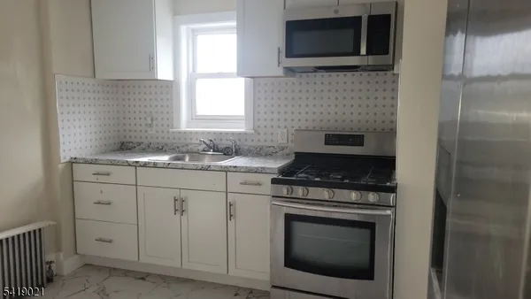 a kitchen with a stove and a microwave