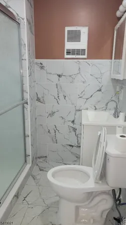 a white toilet sitting next to a bathroom sink