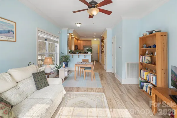 a living room with furniture and a book shelf