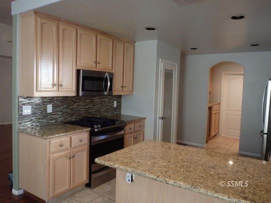 421 Marlene Court Ridgecrest, CA 93555 - Photo 14 of 50 a kitchen with granite countertop white cabinets and stainless steel appliances