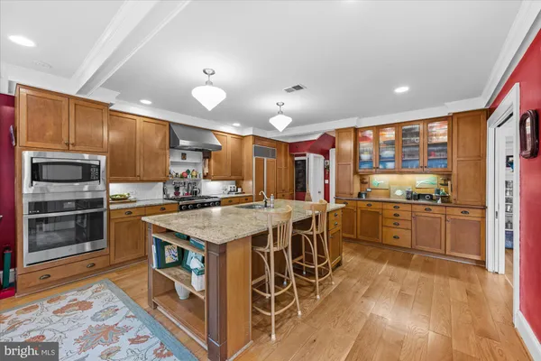a kitchen with stainless steel appliances granite countertop a stove oven and a refrigerator