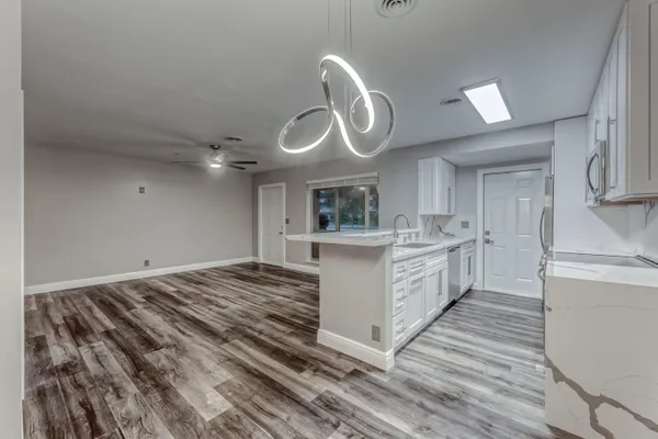 a large kitchen with kitchen island a sink stainless steel appliances and cabinets