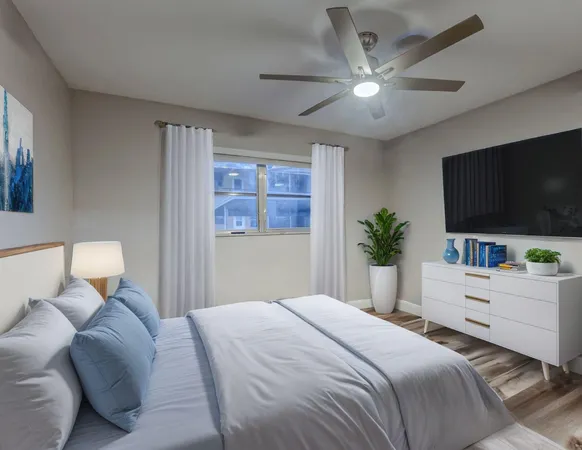 a bedroom with a large bed and a flat screen tv
