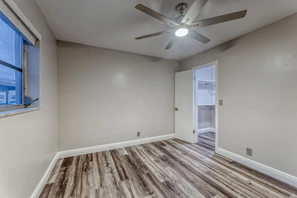 a view of room with window and ceiling fan