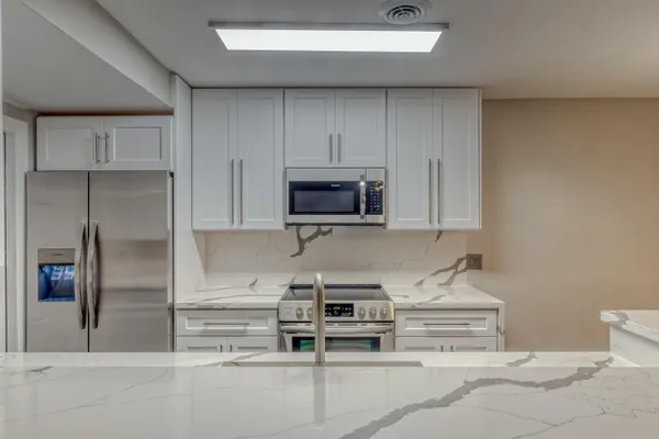 a kitchen with stainless steel appliances a stove and a refrigerator