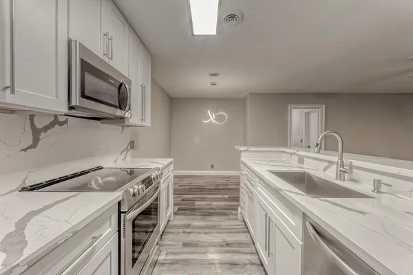 a kitchen with a sink and a stove top oven