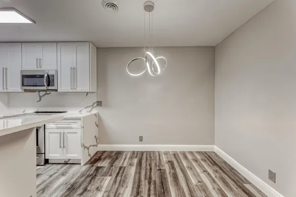 a kitchen with cabinets appliances and a window