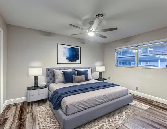 a bedroom with a large bed and a chandelier