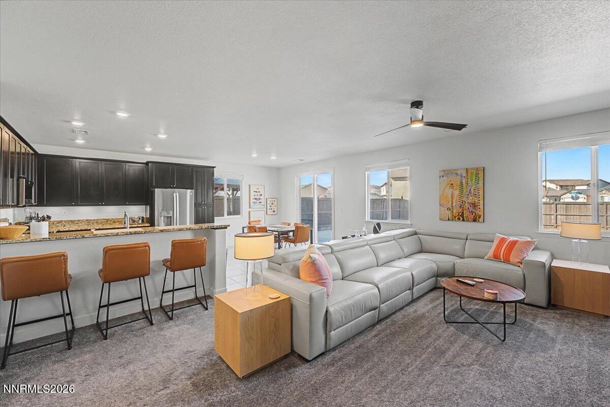 6997 Spencer Ridge Court Sparks, NV 89436 - Photo 1 of 38 a living room with furniture and a flat screen tv