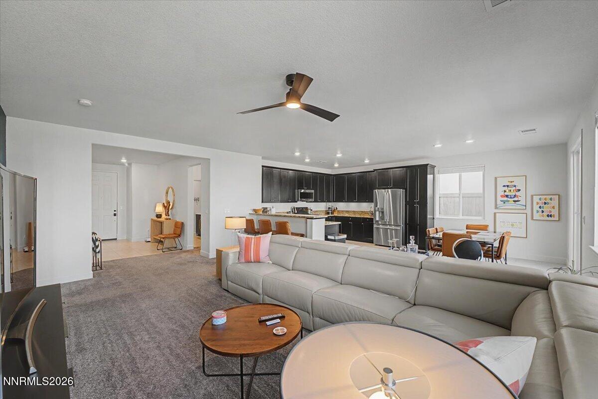 6997 Spencer Ridge Court Sparks, NV 89436 - Photo 11 of 38 a living room with furniture kitchen view and a chandelier