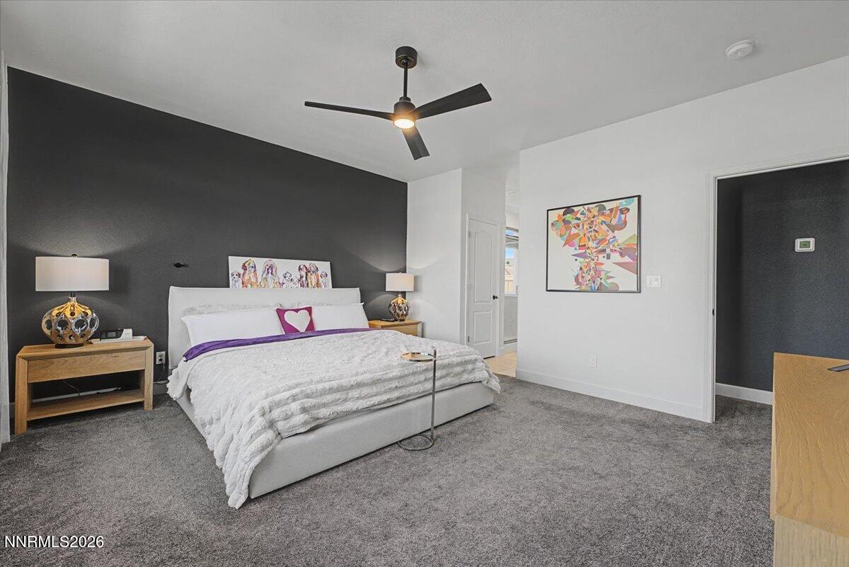 6997 Spencer Ridge Court Sparks, NV 89436 - Photo 13 of 38 a bedroom with a bed and a ceiling fan