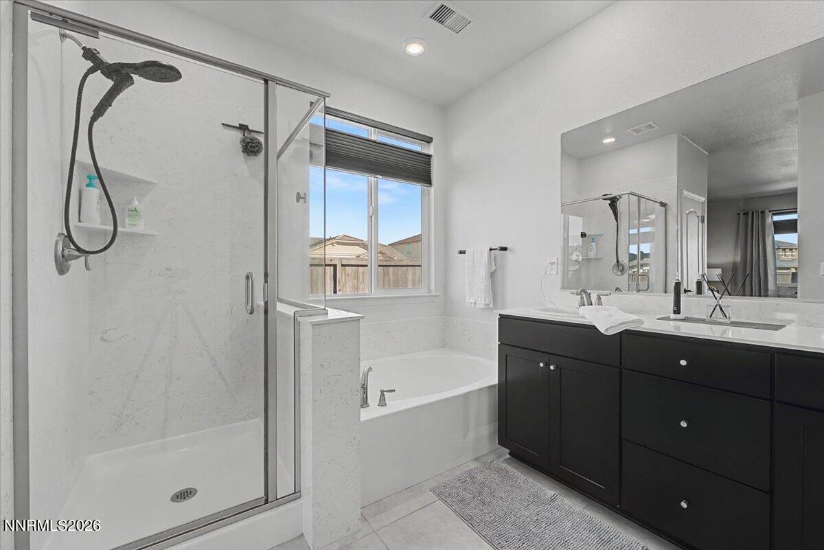 6997 Spencer Ridge Court Sparks, NV 89436 - Photo 16 of 38 a bathroom with a bath tub sink vanity and mirror
