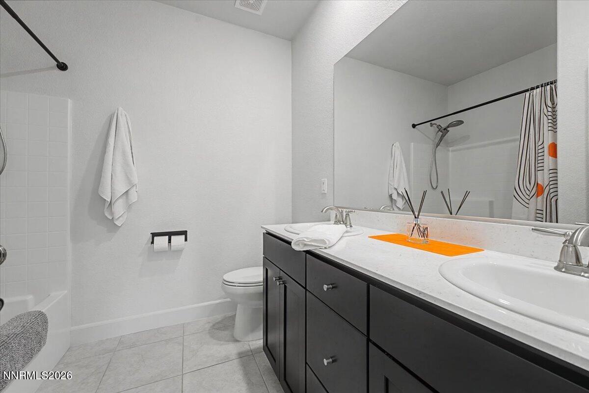 6997 Spencer Ridge Court Sparks, NV 89436 - Photo 20 of 38 a bathroom with a granite countertop sink and a mirror