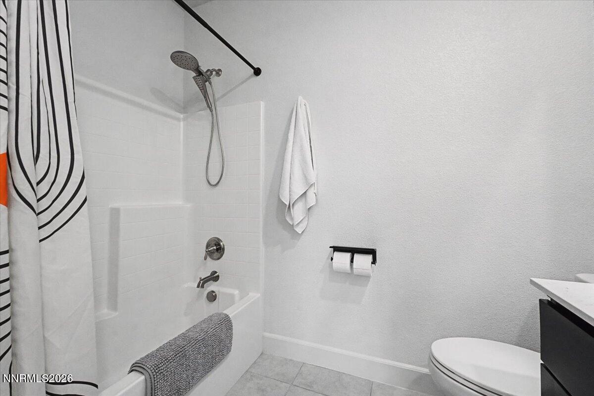 6997 Spencer Ridge Court Sparks, NV 89436 - Photo 21 of 38 a bathroom with a granite countertop shower and a toilet