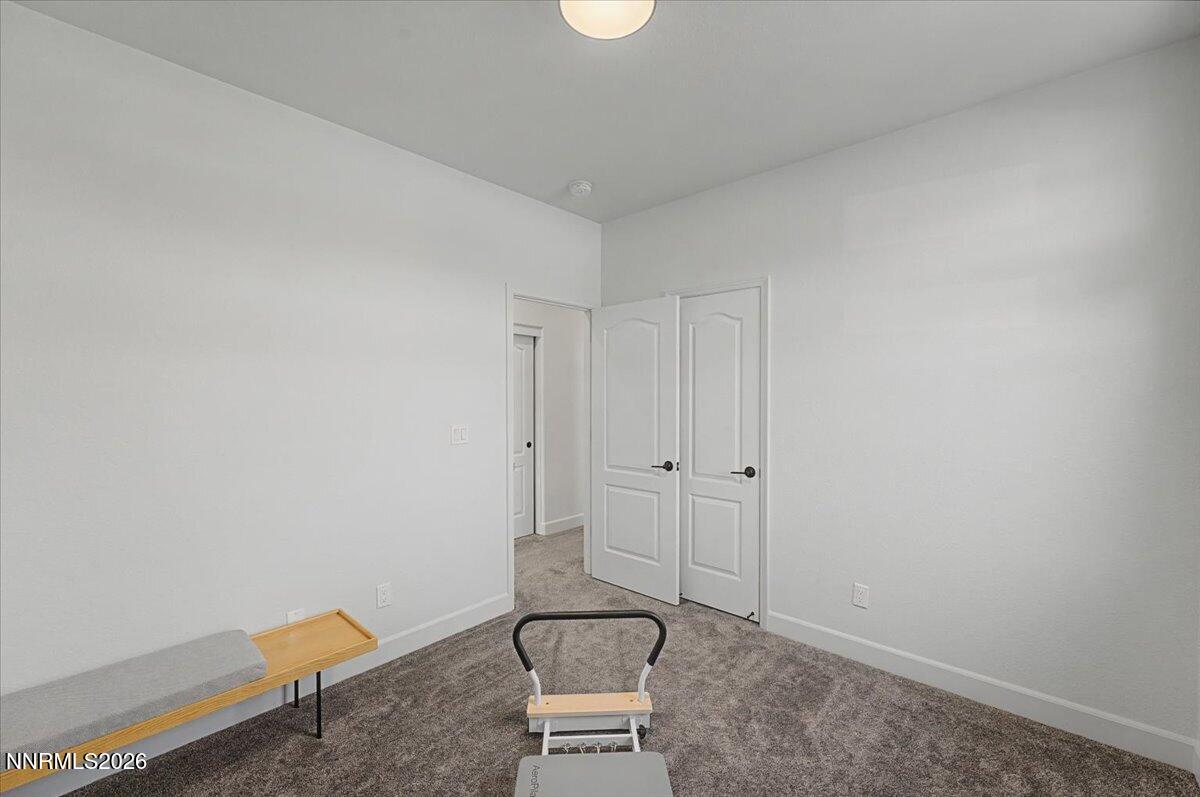 6997 Spencer Ridge Court Sparks, NV 89436 - Photo 26 of 38 a room with a chair and potted plant