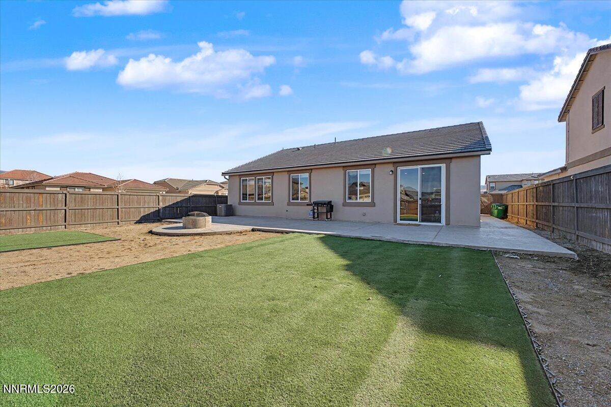 6997 Spencer Ridge Court Sparks, NV 89436 - Photo 29 of 38 a view of a house with a backyard porch and sitting area
