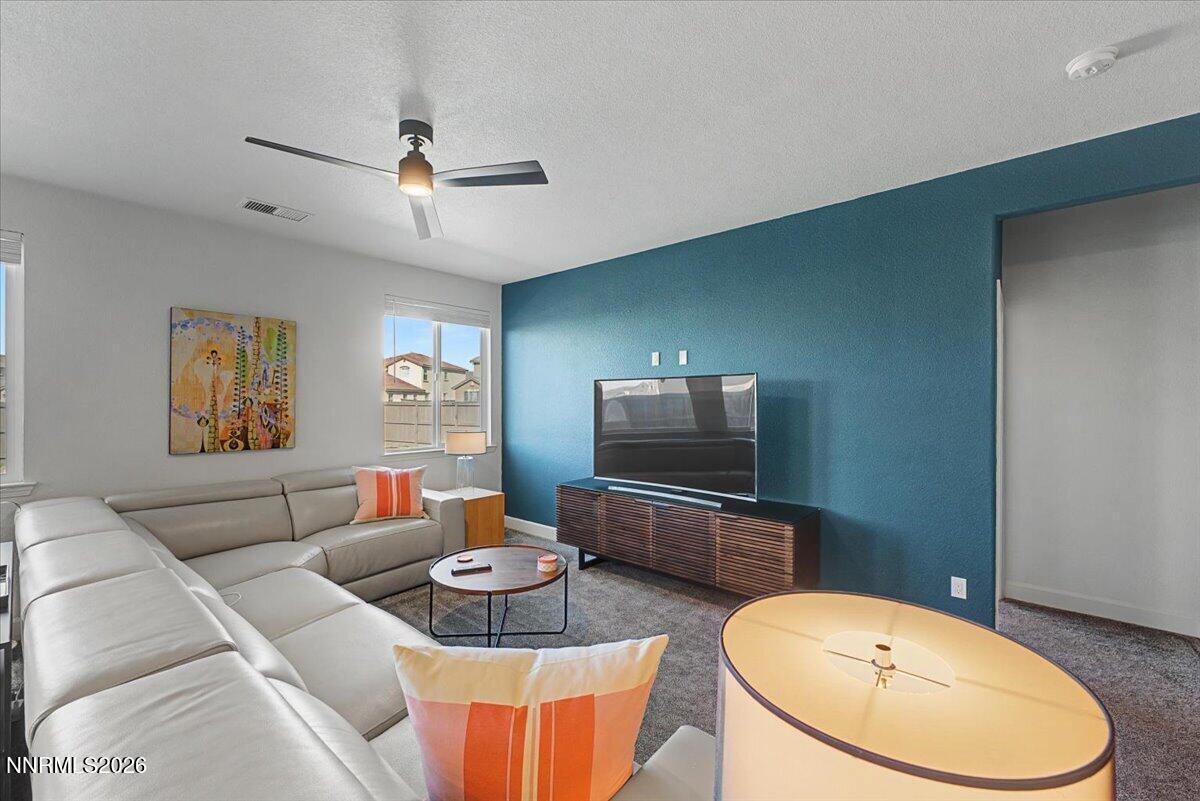 6997 Spencer Ridge Court Sparks, NV 89436 - Photo 6 of 38 a living room with furniture and a flat screen tv