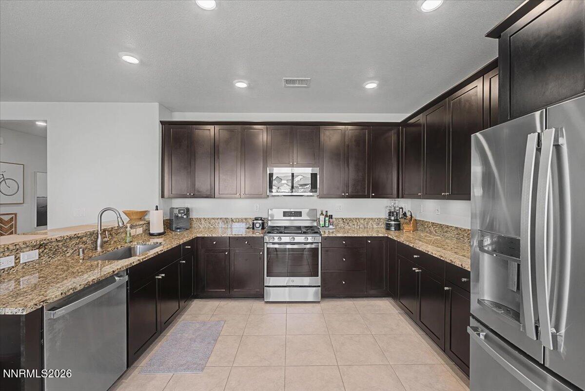 6997 Spencer Ridge Court Sparks, NV 89436 - Photo 8 of 38 a kitchen with a sink and stainless steel appliances