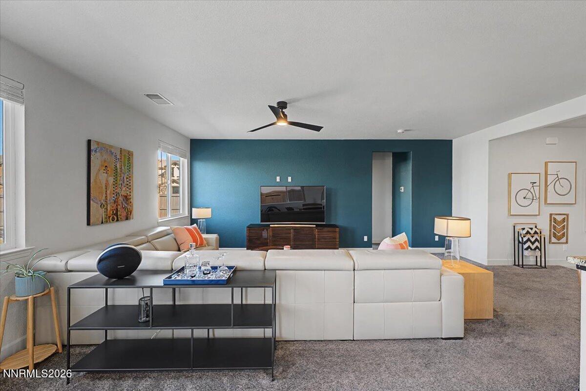 6997 Spencer Ridge Court Sparks, NV 89436 - Photo 9 of 38 a living room with furniture and a chandelier