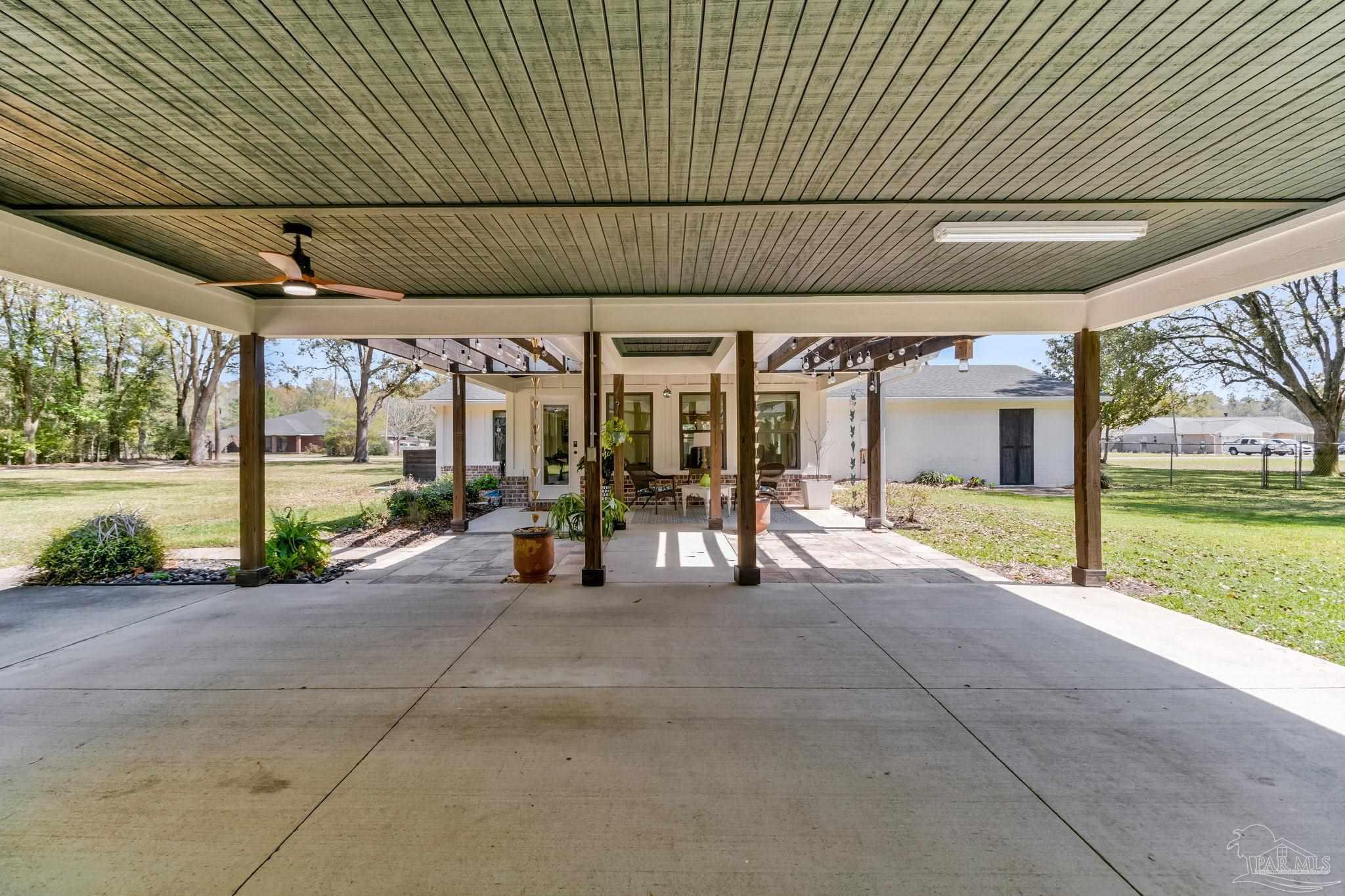7175 Wallace Drive Pace, FL 32571 - Photo 14 of 71 a view of a patio with table and chairs under an umbrella