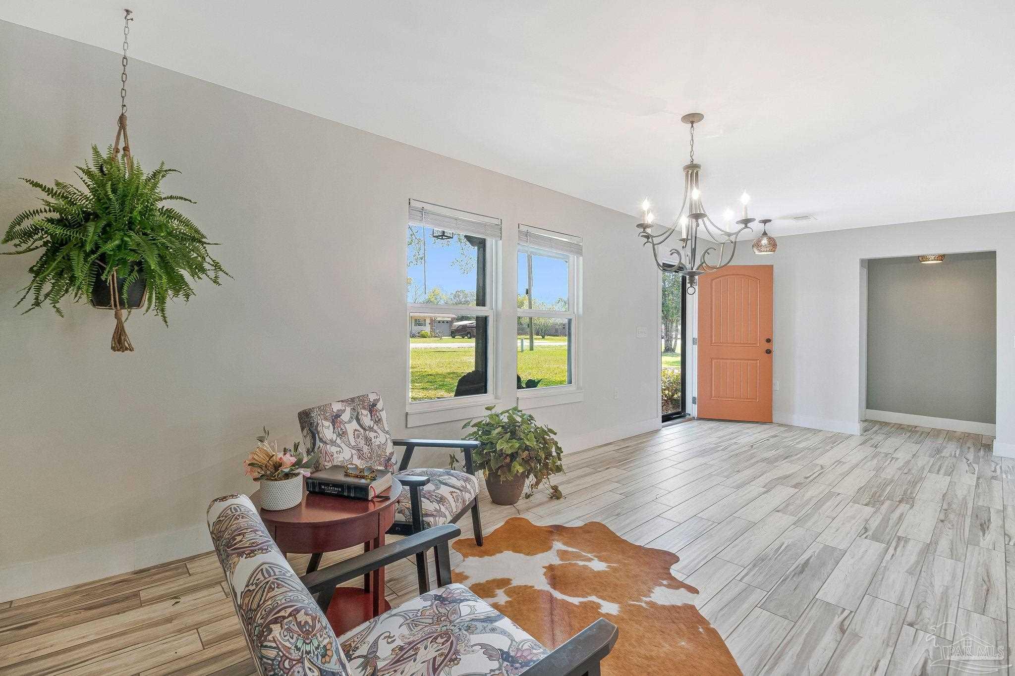 7175 Wallace Drive Pace, FL 32571 - Photo 19 of 71 a living room with furniture and a chandelier
