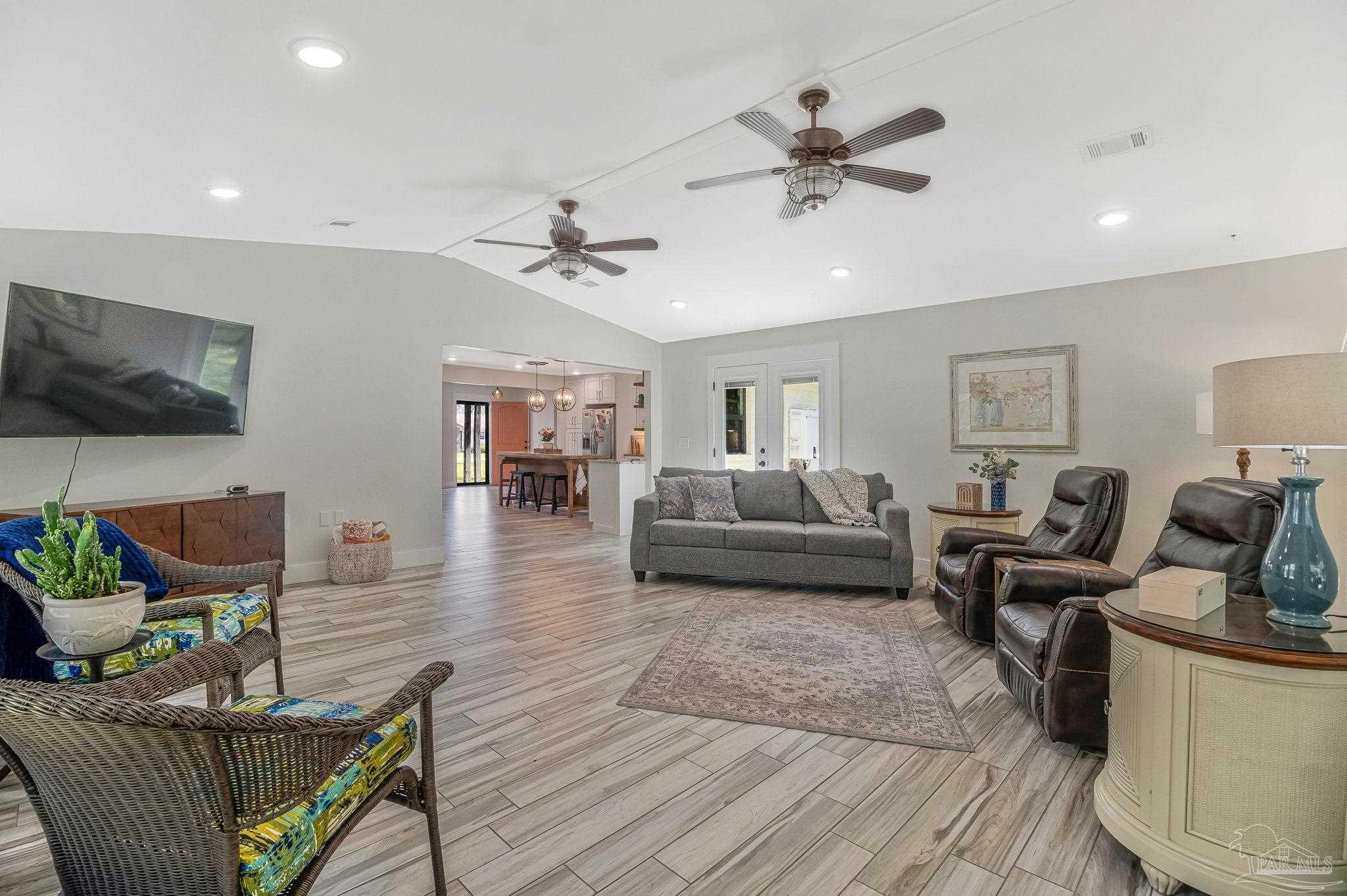 7175 Wallace Drive Pace, FL 32571 - Photo 32 of 71 a living room with furniture and a flat screen tv