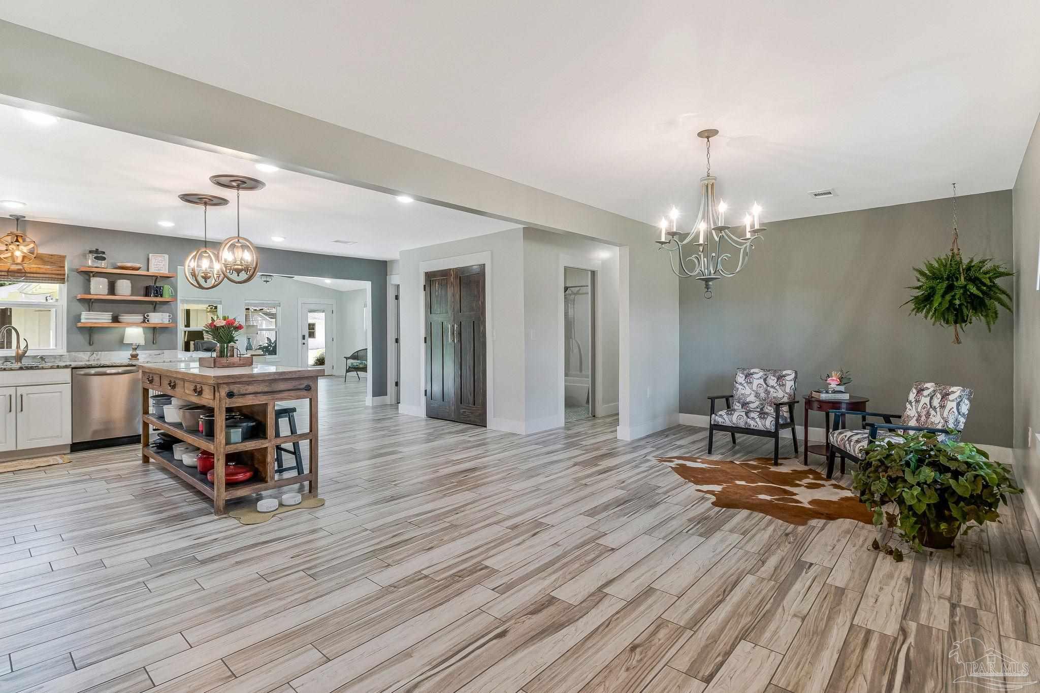 7175 Wallace Drive Pace, FL 32571 - Photo 33 of 71 a living room with furniture and a chandelier