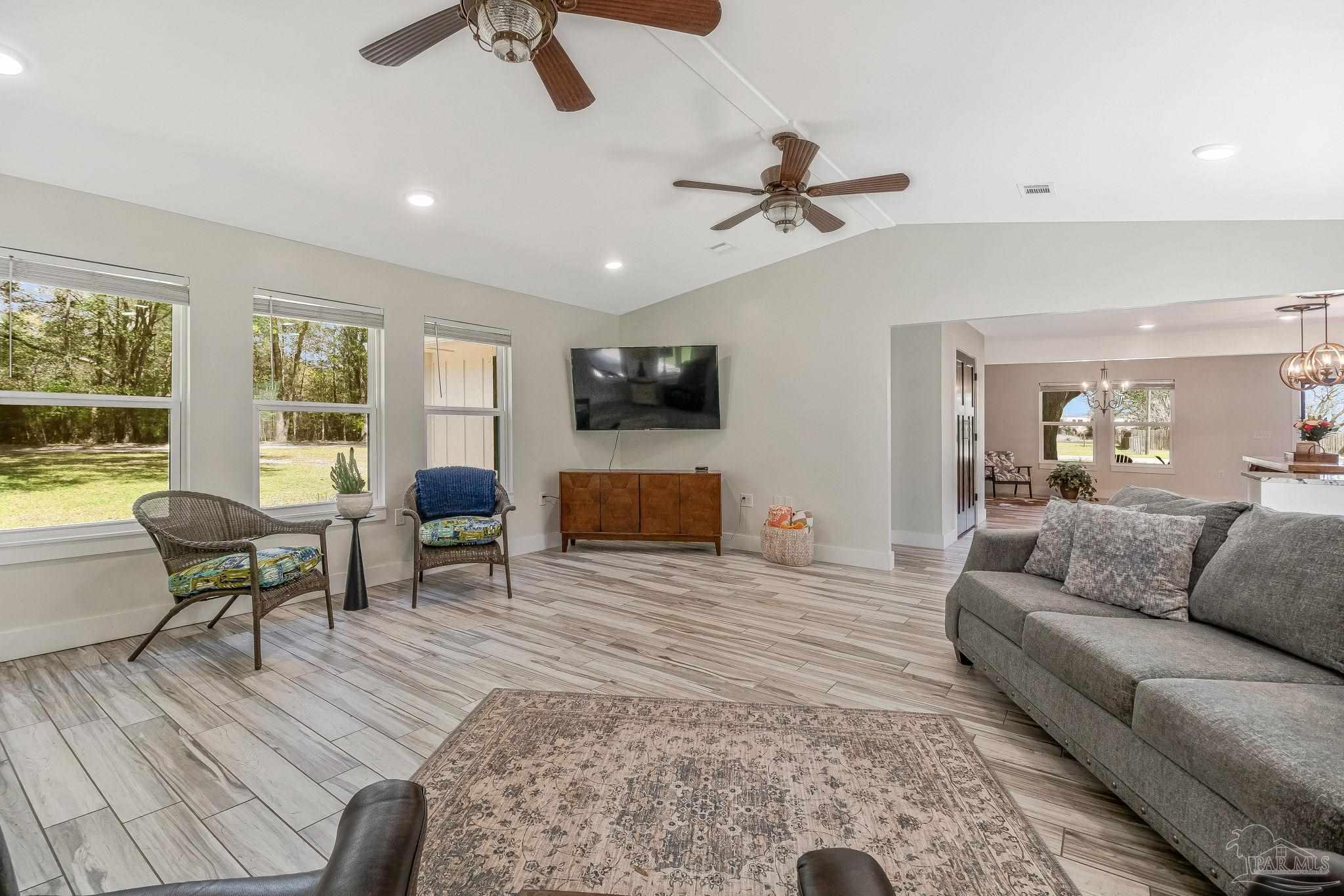 7175 Wallace Drive Pace, FL 32571 - Photo 35 of 71 a living room with furniture and a flat screen tv