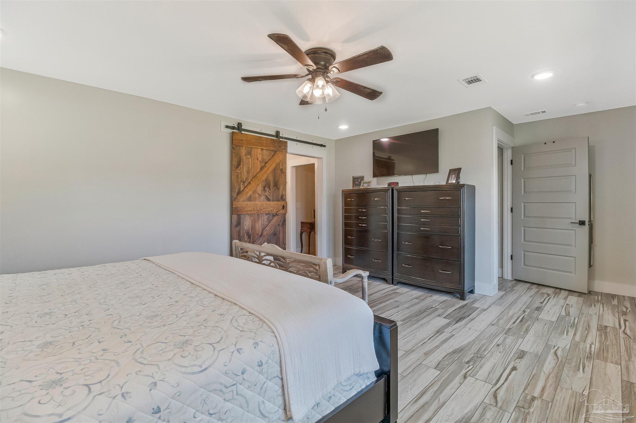 7175 Wallace Drive Pace, FL 32571 - Photo 37 of 71 a bedroom with a bed and a ceiling fan