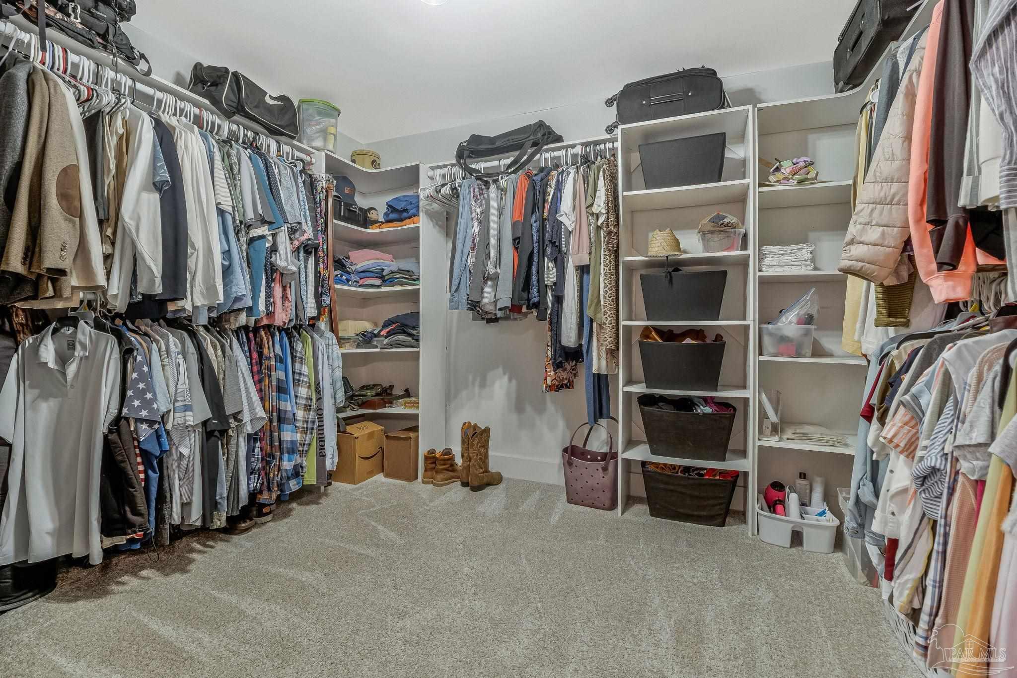 7175 Wallace Drive Pace, FL 32571 - Photo 42 of 71 a view of walk in closet with clothes and shoes