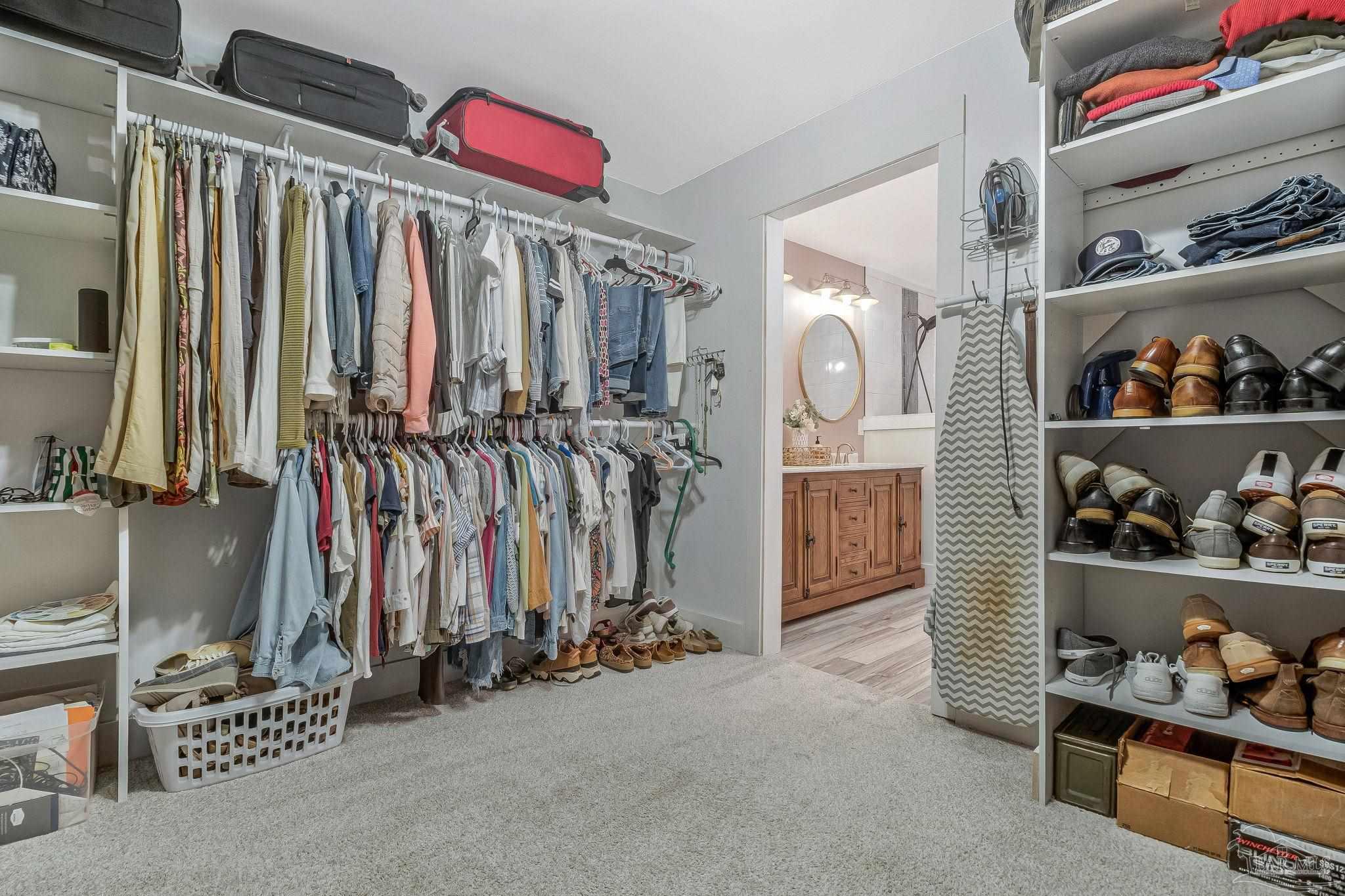 7175 Wallace Drive Pace, FL 32571 - Photo 43 of 71 a view of walk in closet with clothes and shoes