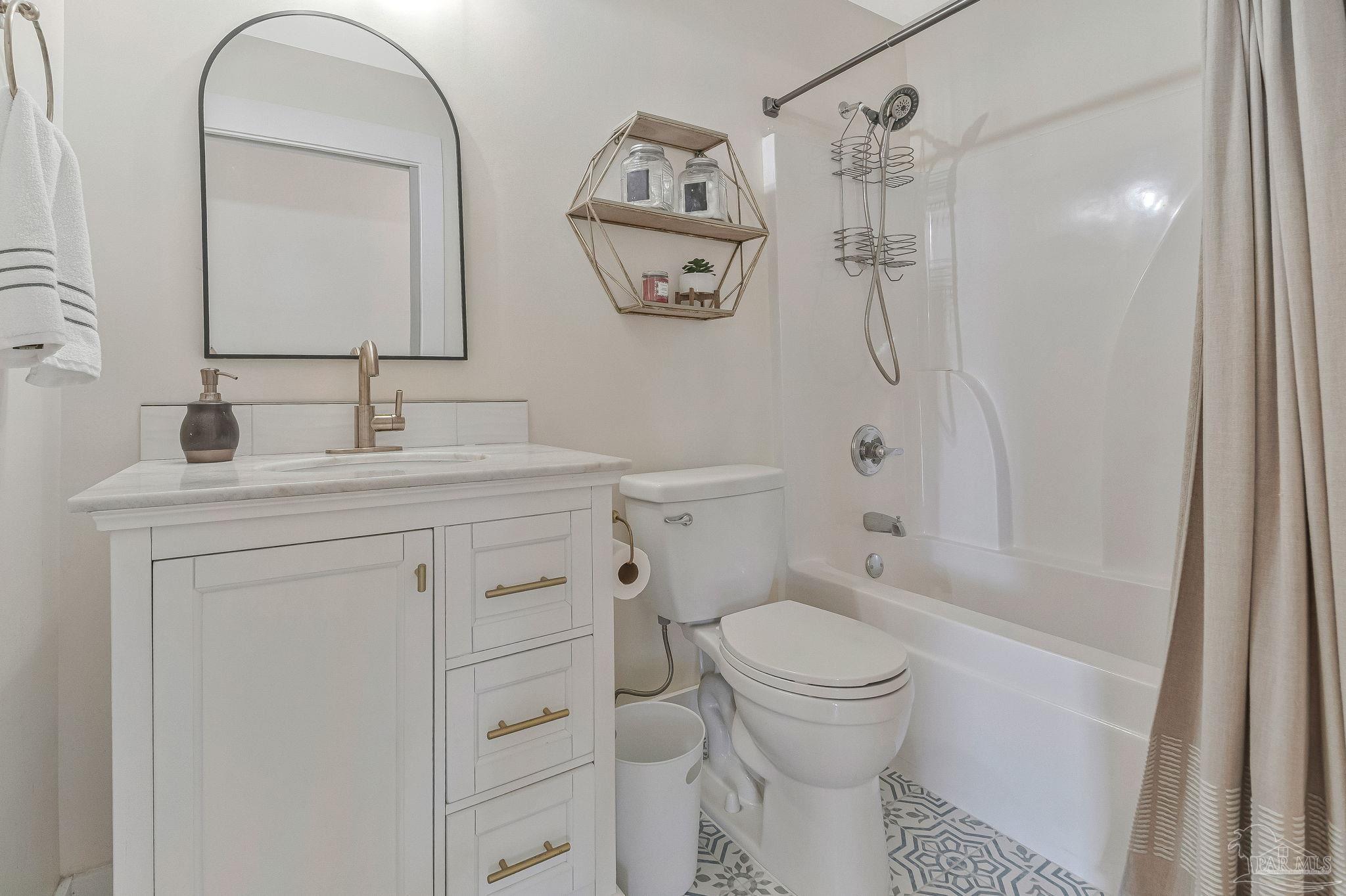 7175 Wallace Drive Pace, FL 32571 - Photo 49 of 71 a bathroom with a toilet sink vanity granite and shower