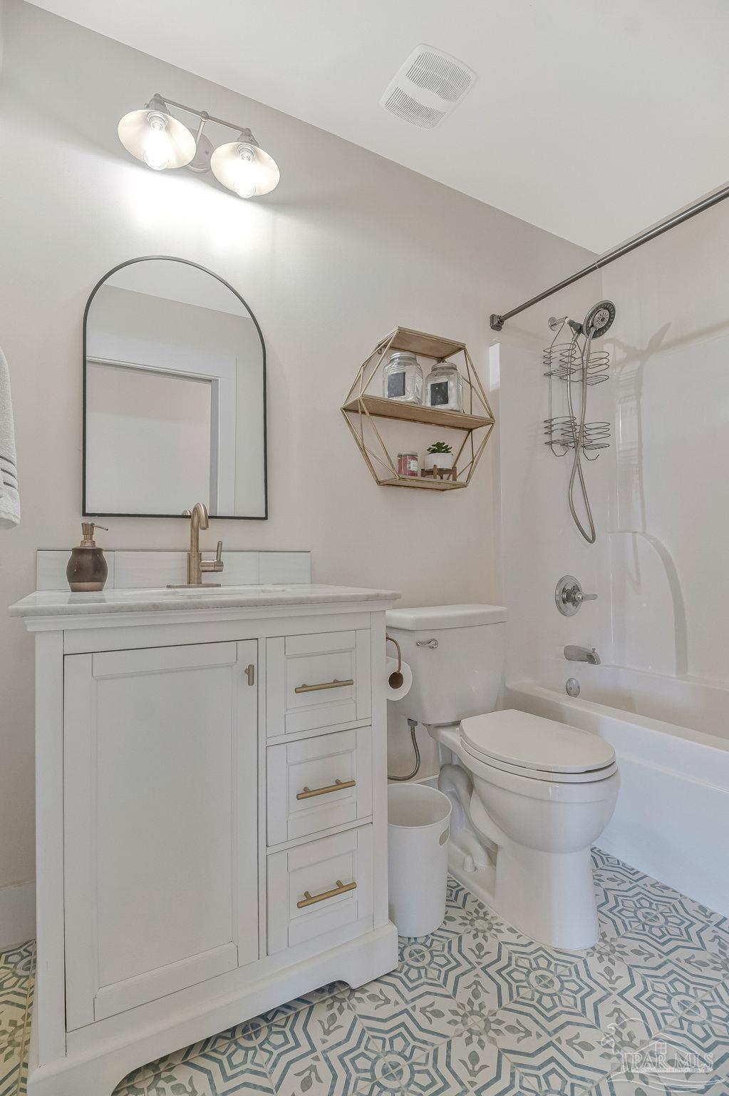 7175 Wallace Drive Pace, FL 32571 - Photo 50 of 71 a bathroom with a toilet sink and mirror