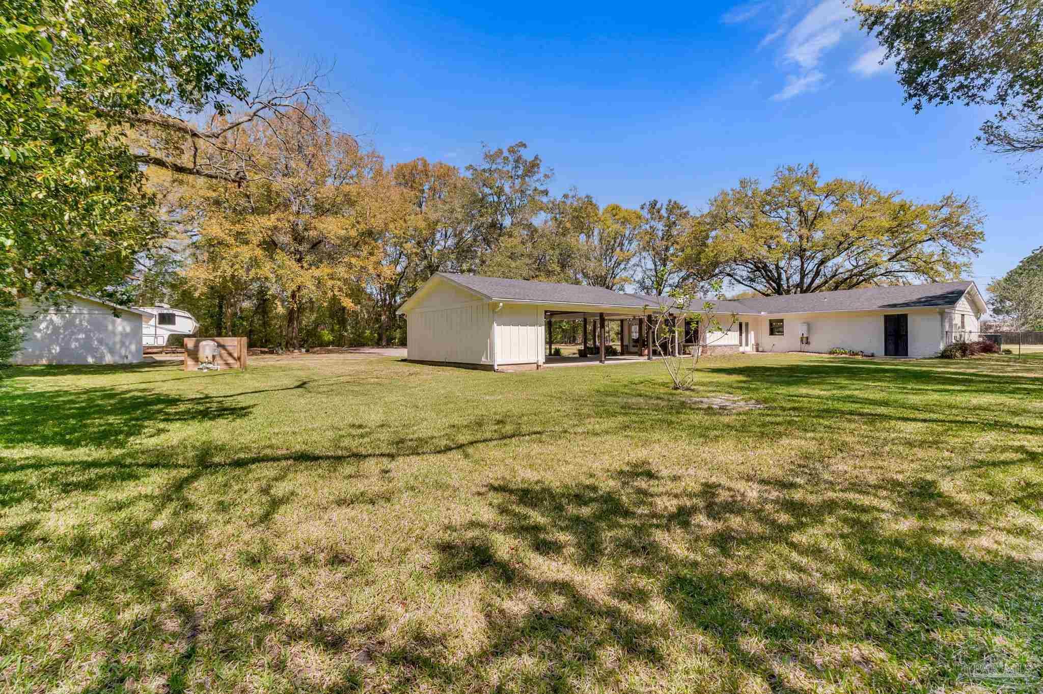 7175 Wallace Drive Pace, FL 32571 - Photo 7 of 71 a view of a house with a yard