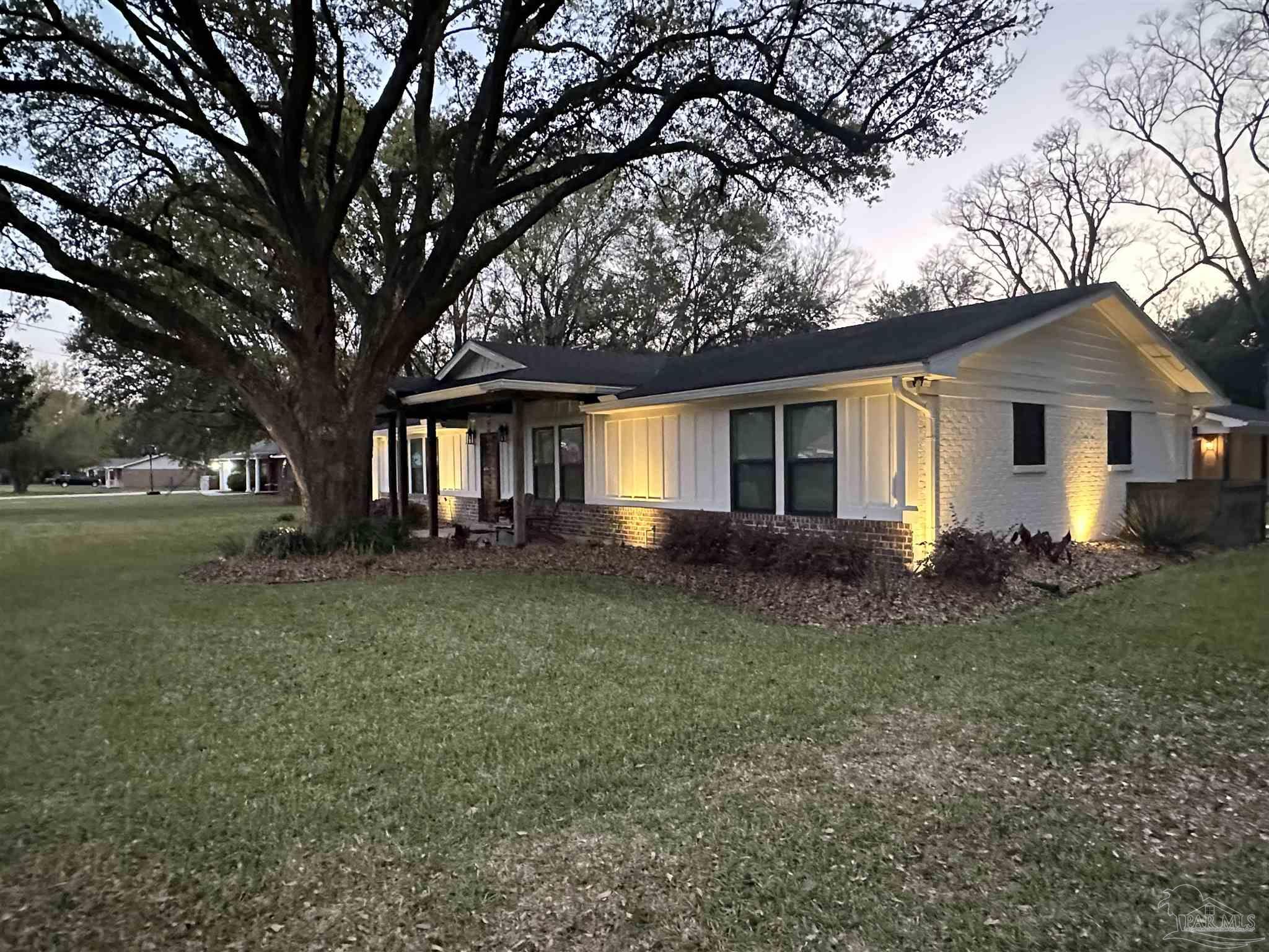 7175 Wallace Drive Pace, FL 32571 - Photo 8 of 71 a front view of a house with garden