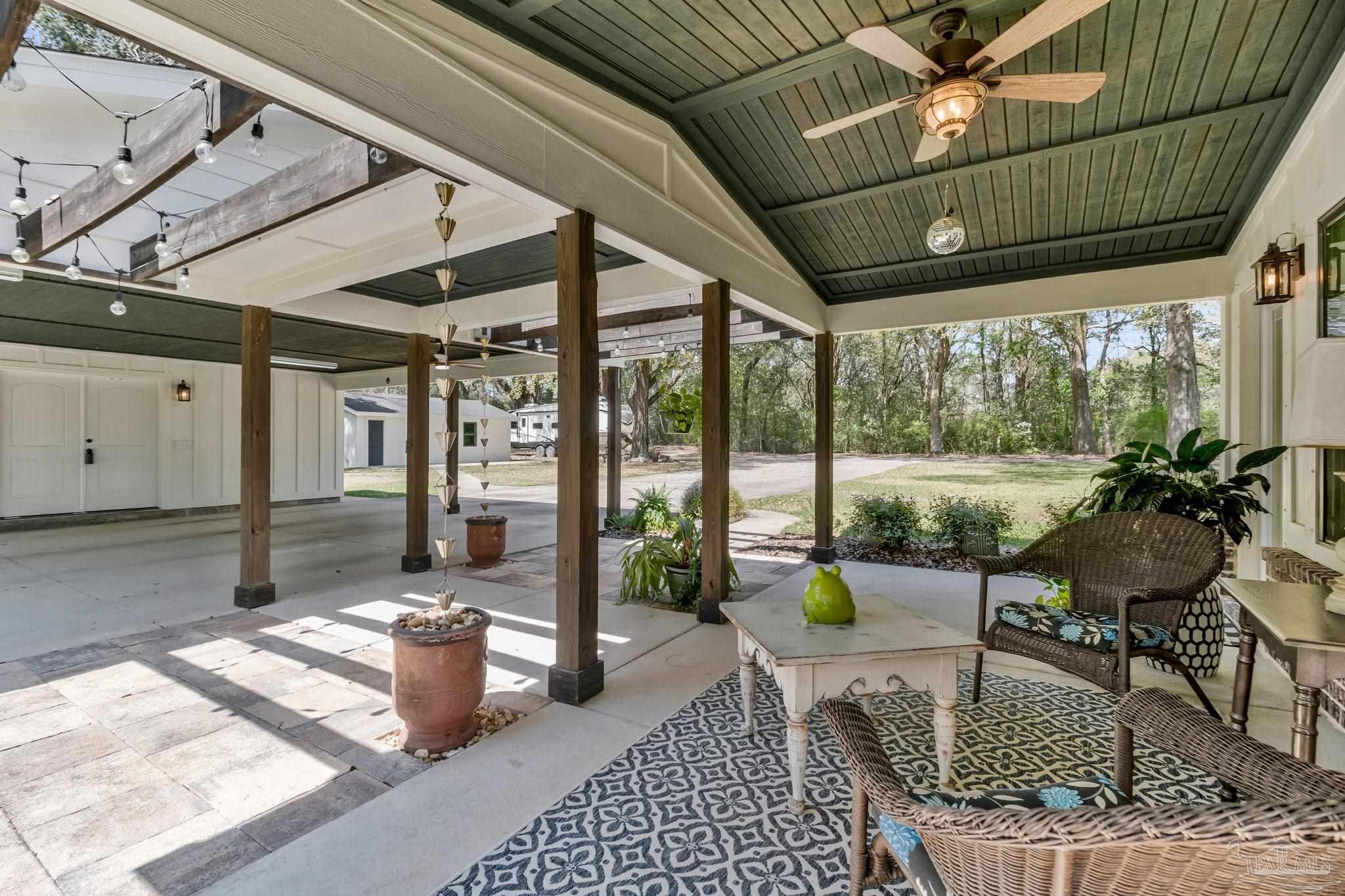 7175 Wallace Drive Pace, FL 32571 - Photo 10 of 71 a balcony with furniture and a potted plant