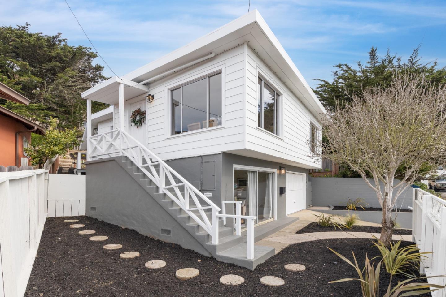 a view of house with a yard and balcony