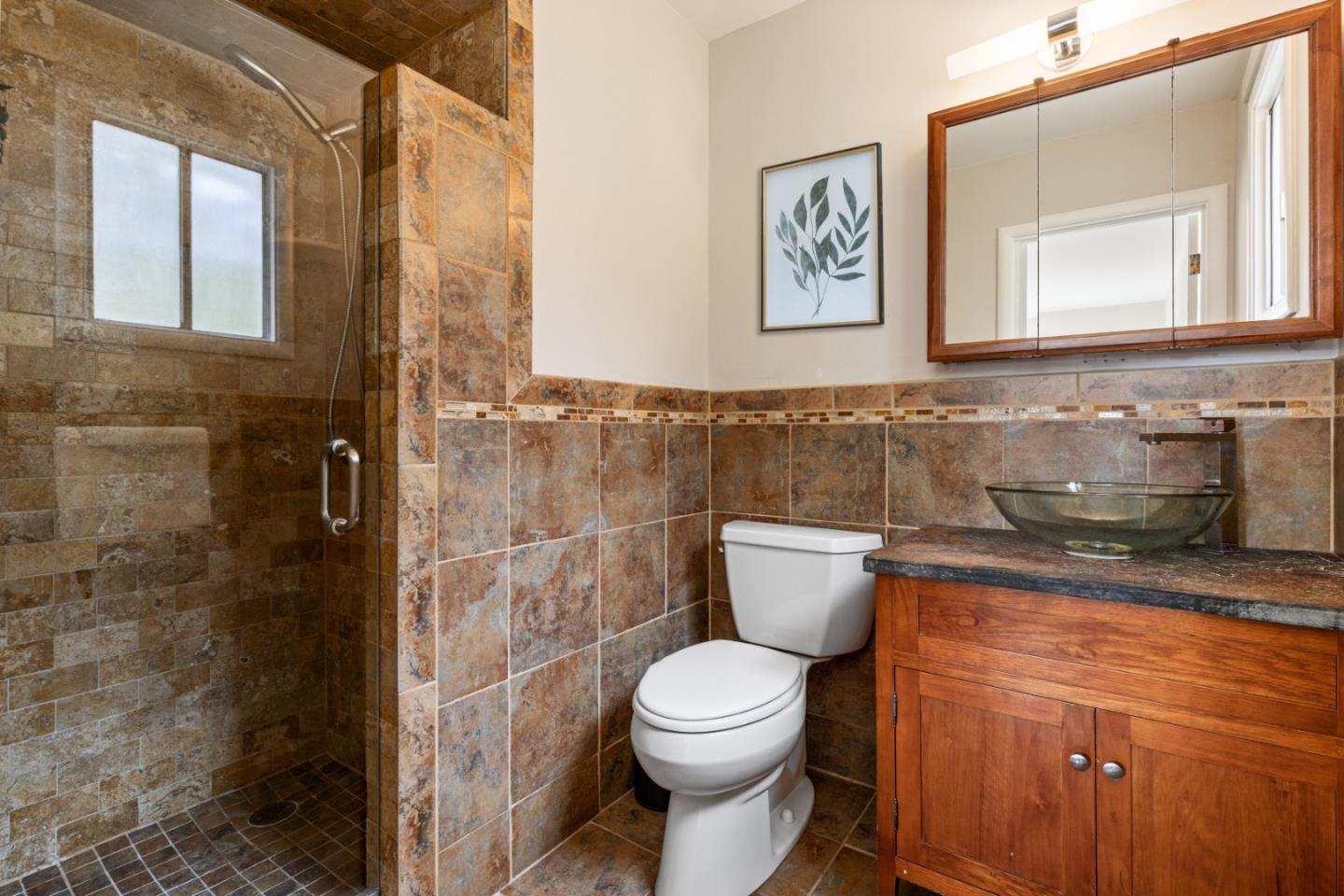 401 Monterey Road Pacifica, CA 94044 - Photo 19 of 39 a bathroom with a toilet a sink and mirror