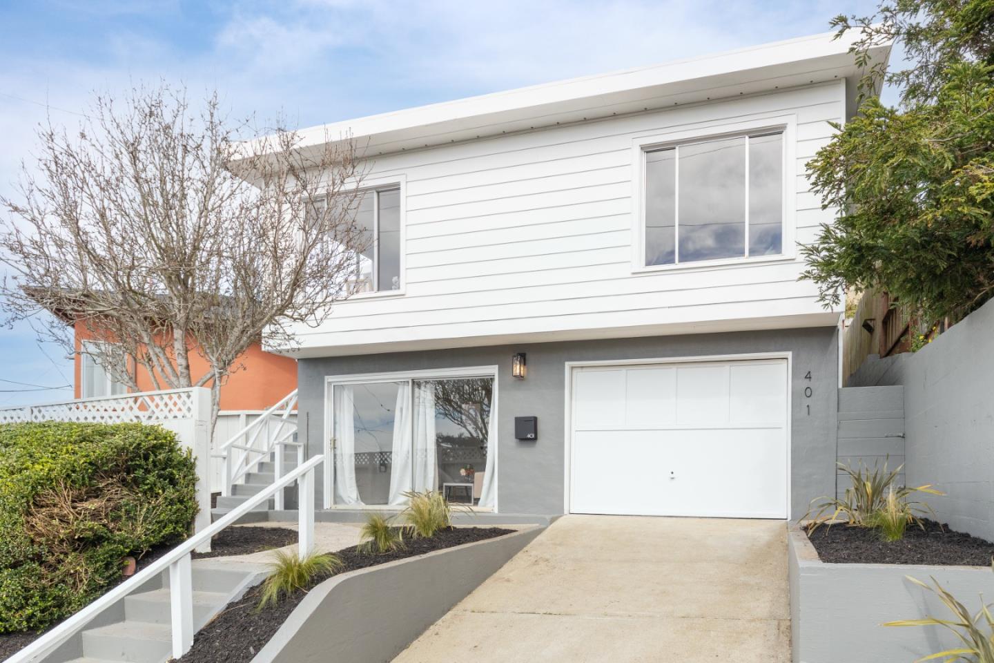 401 Monterey Road Pacifica, CA 94044 - Photo 2 of 39 a front view of a house with a yard garage and outdoor seating