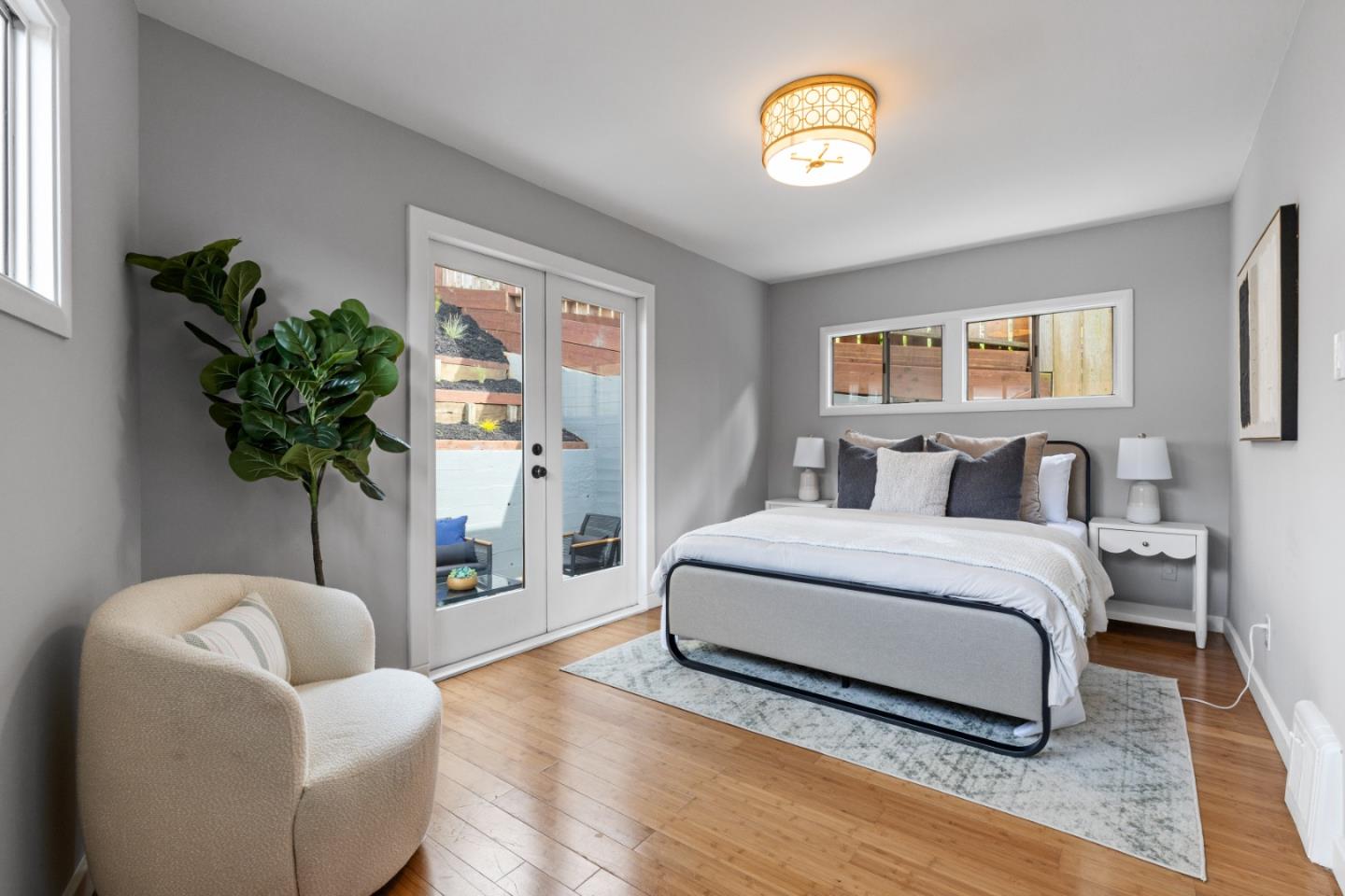 401 Monterey Road Pacifica, CA 94044 - Photo 23 of 39 a spacious bedroom with a bed and a potted plant