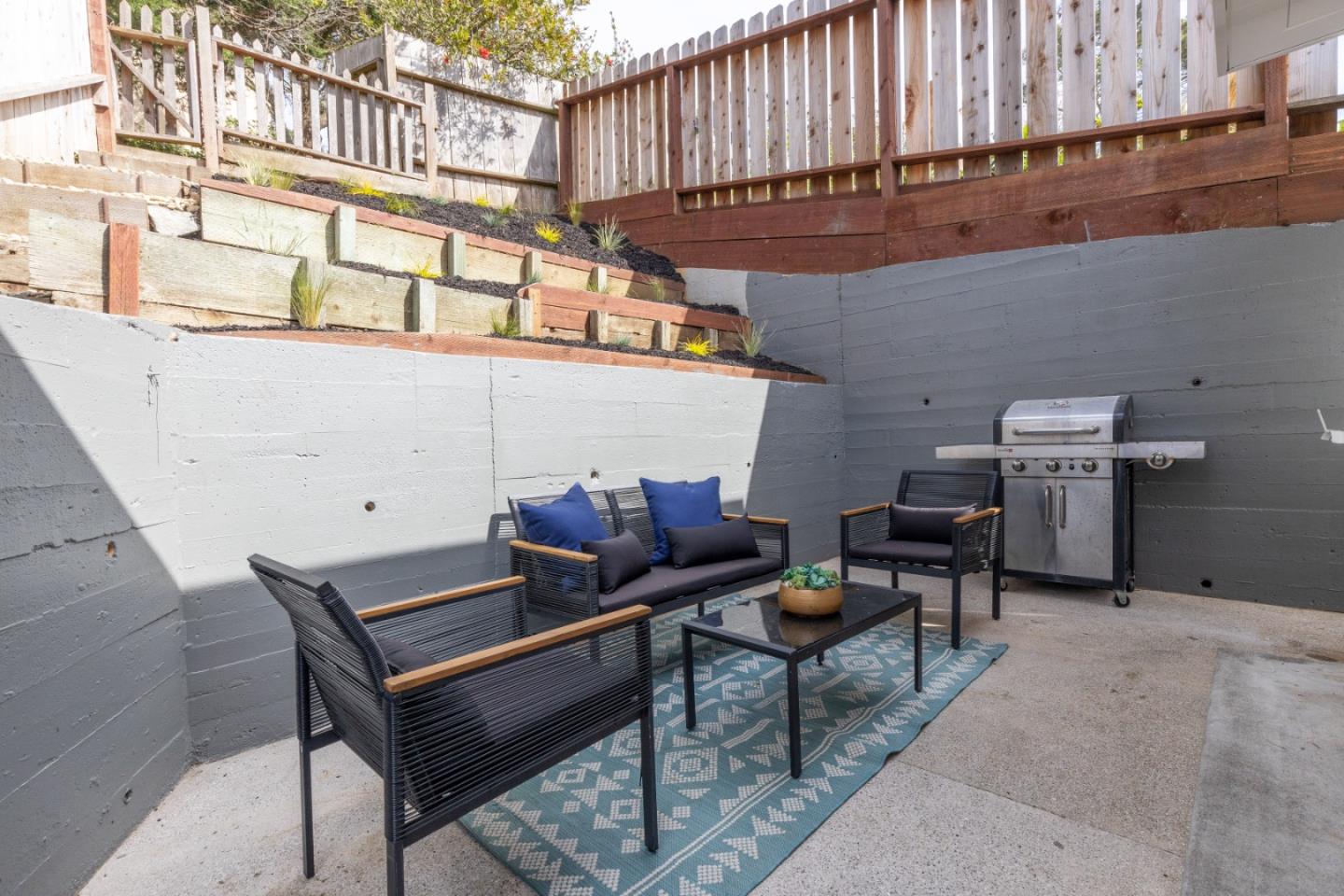 401 Monterey Road Pacifica, CA 94044 - Photo 26 of 39 a outdoor sitting area with a table and chair
