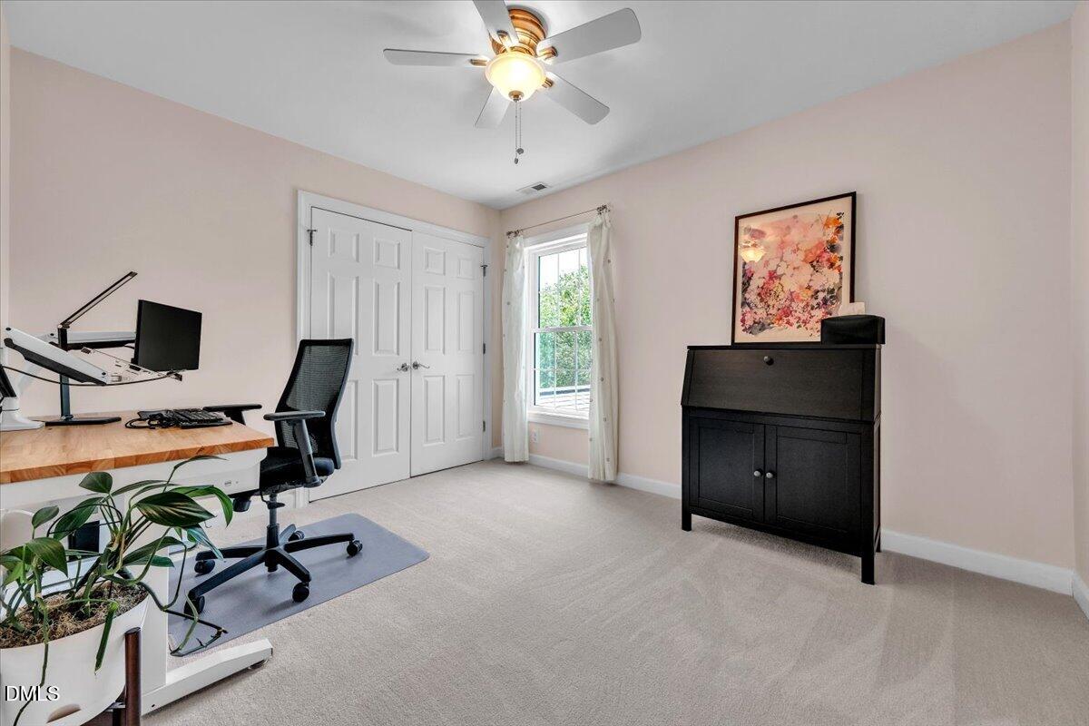 2908 Oak Bridge Drive Raleigh, NC 27610 - Photo 28 of 47 a view of a workspace with furniture and a window
