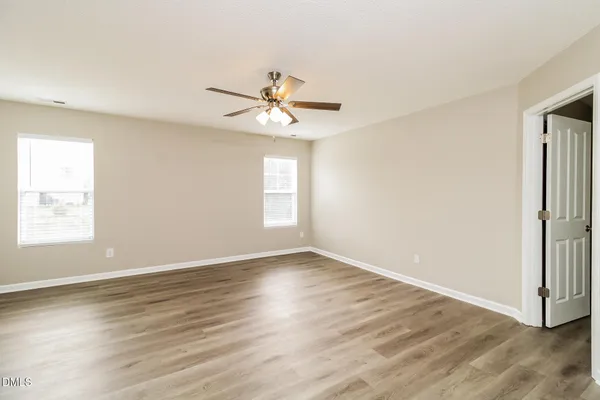 a kitchen with granite countertop a refrigerator stove a sink and dishwasher with wooden floor